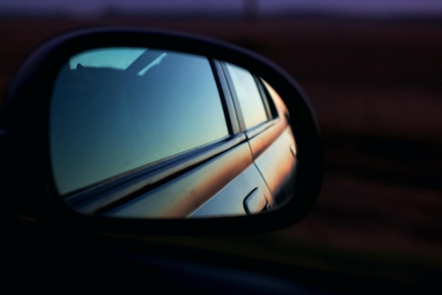 Car mirror at sunset in the dark