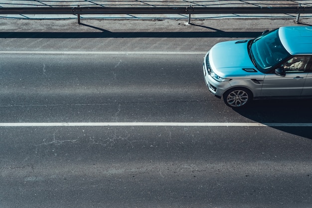 Car moving on empty road lane