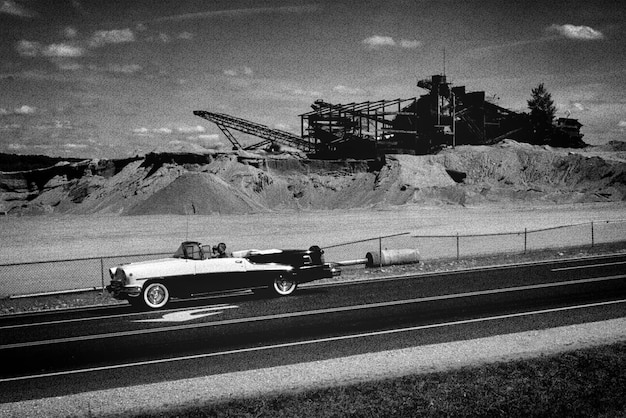 Car moving on road by construction site