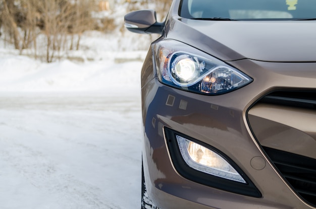 Car in nature. Car headlight of a brown car