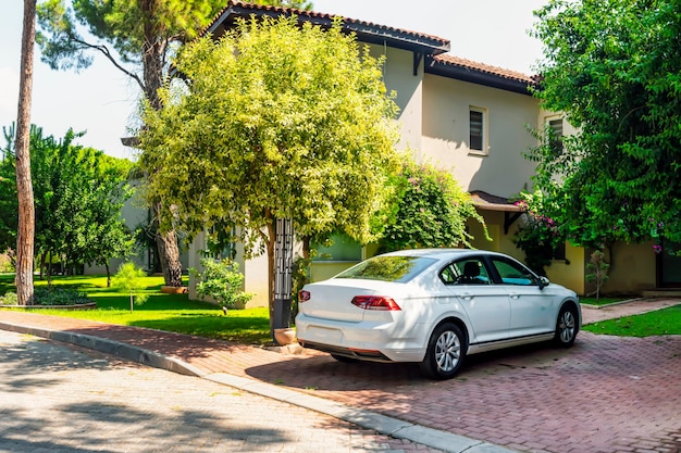 Car near the house in a modern area comfortable housing mortgage parking apartment house in the suburbs