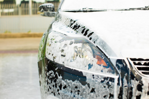 Car in outdoors selfservice car wash car in foam toned