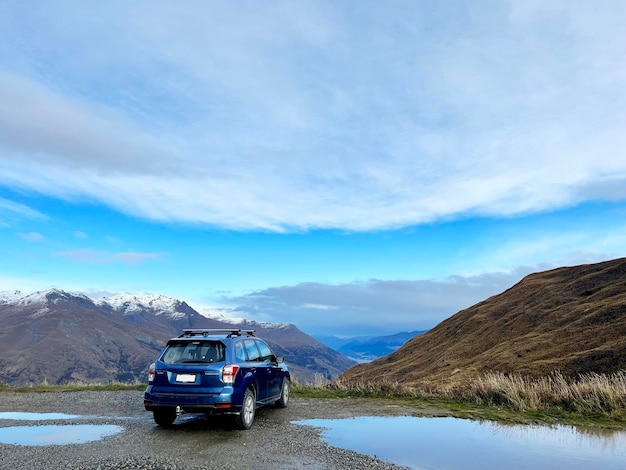 A car park on a high mountain view with blue sky crown range road new zealand 2023