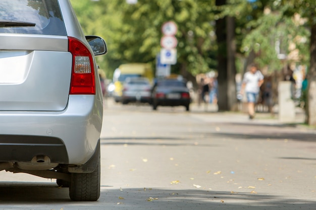 A car parked near curb on the side of the street on a parking lot.