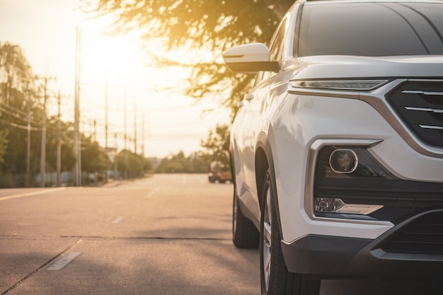 Car parked on road sunset evening