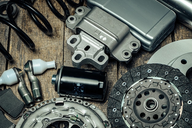 Car parts set on wooden background close up