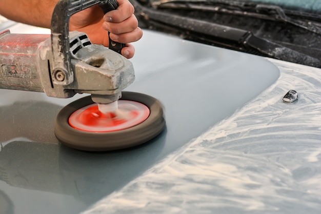 Photo car polishing in autoservice selective focus