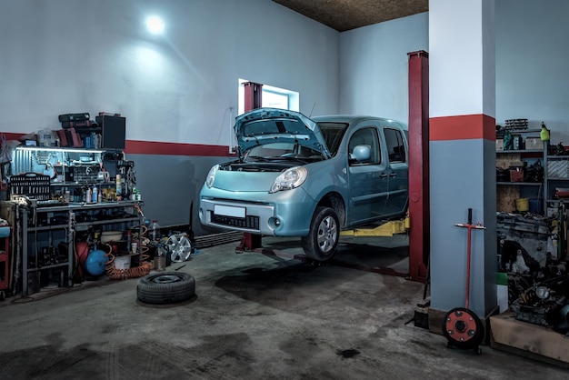 Car raised on car lift in auto service