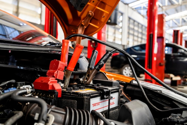 Car repair concept closeup charging car battery