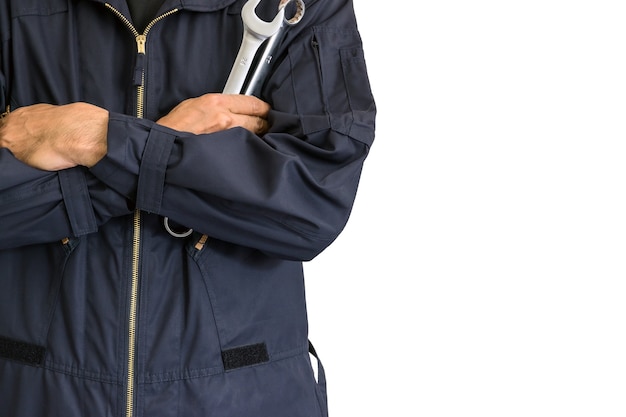 Car repairman wearing a dark blue uniform holding a wrench on white background.