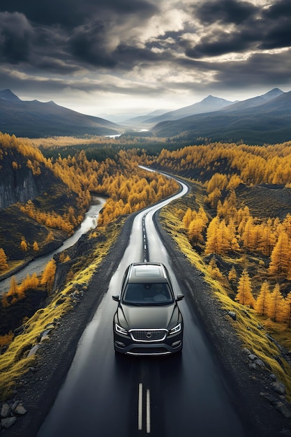 car rides on the highway road in nature with mountains and forests in autumn on a journey Top view from a drone