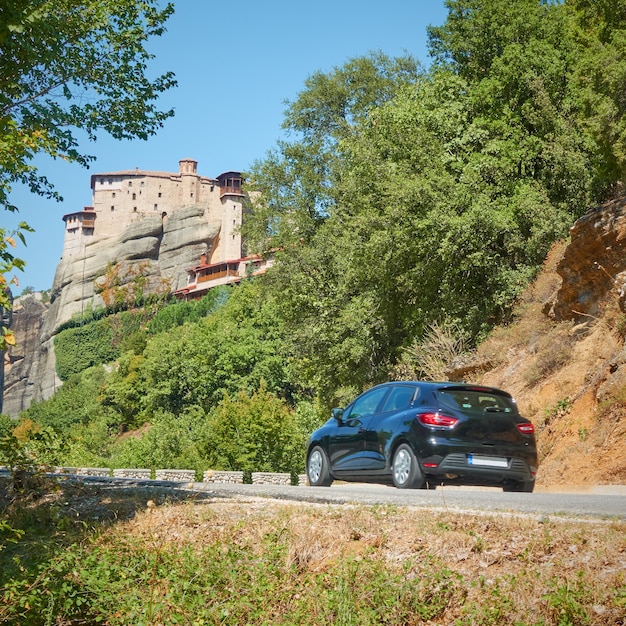 Car on the road to The Monastery of Rousanou in Meteora,  Greece