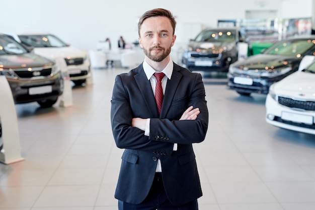 Car Salesman Posing in Showroom