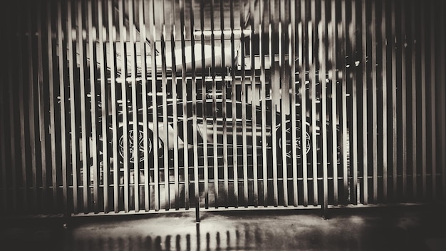 Car seen through metallic railing