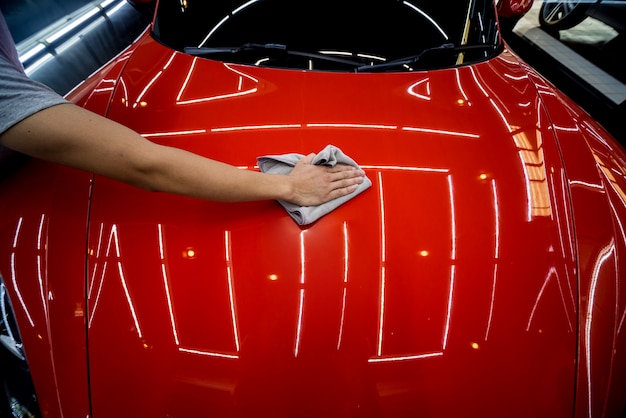 Photo car service worker applying nano coating on a car detail