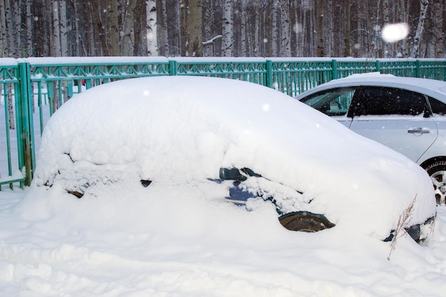 Car under snow bad weather in winter