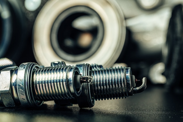 Car spark plugs on black background close up