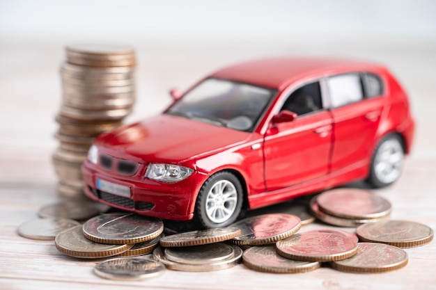 Car on stack of coins. Car loan, Finance, saving money, insurance and leasing time concepts.