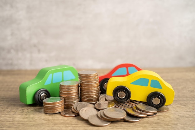 Car on stack of coins Car loan Finance saving money insurance and leasing time concepts