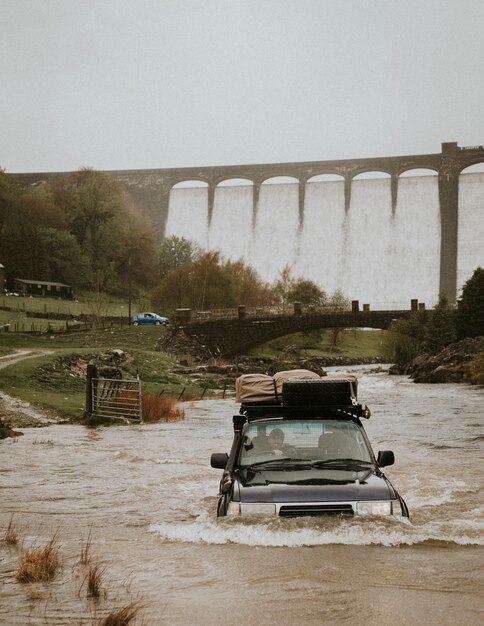 Car stuck in a flood near the dam structure