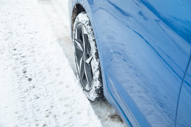 Car tire in winter on the road