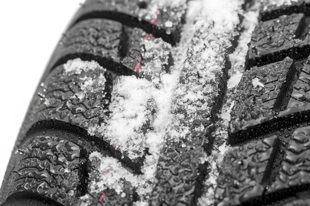 Car tires close-up Winter wheel profile structure with snow on white background