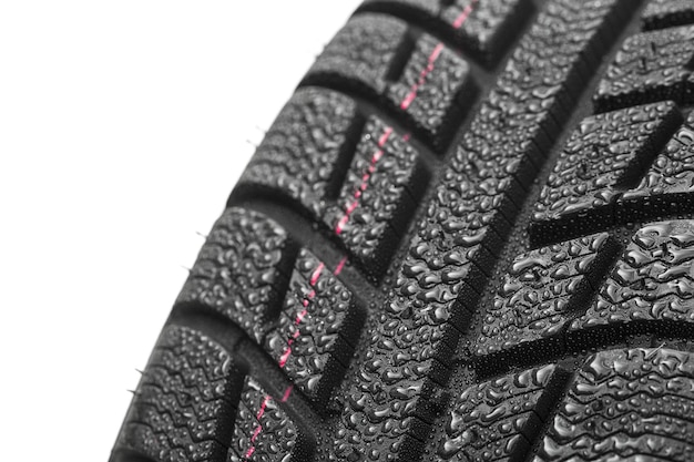 Car tires close-up Winter wheel profile structure with water drops on white background