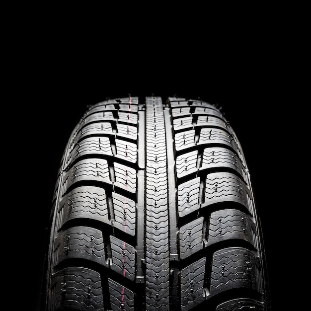 Car tires closeup Winter wheel profile structure on black background