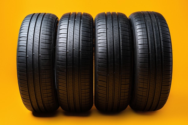 Car tires isolated on yellow background close up