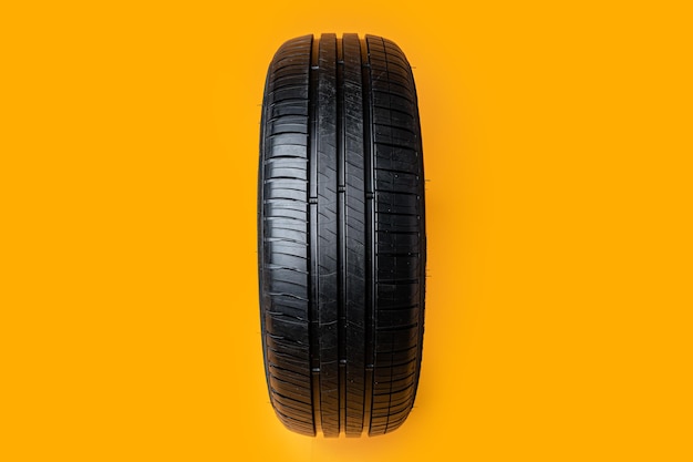 Car tires isolated on yellow background close up