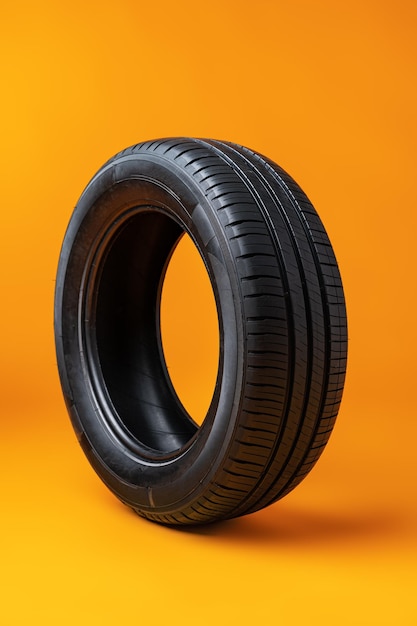 Car tires isolated on yellow background close up