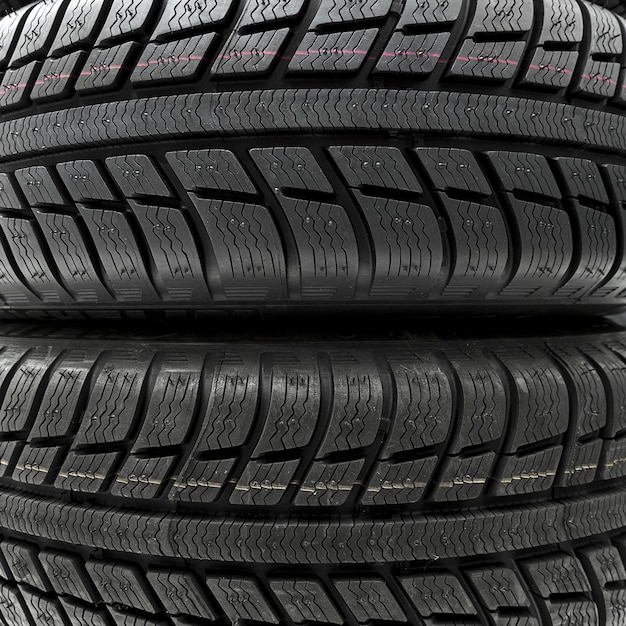 Car tires mature stack close-up Winter wheel profile structure on white background