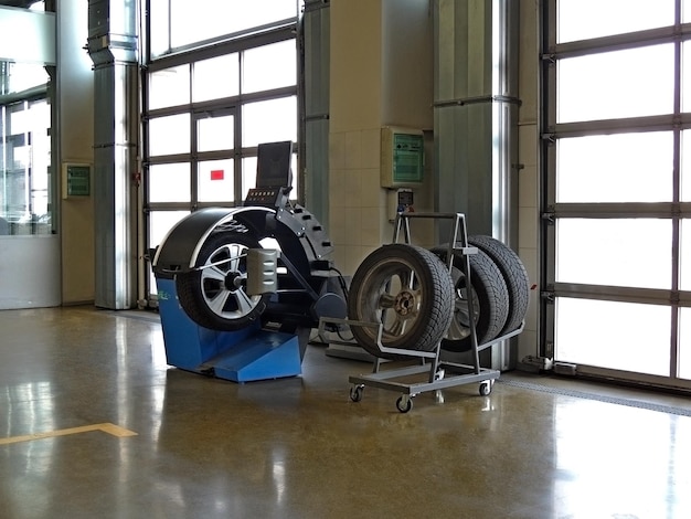 Car tires near fitting machine at service station