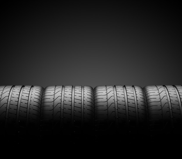 Car tires in row isolated on dark 