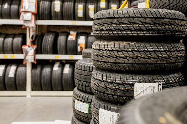 Car tires and wheels at warehouse in tire store.