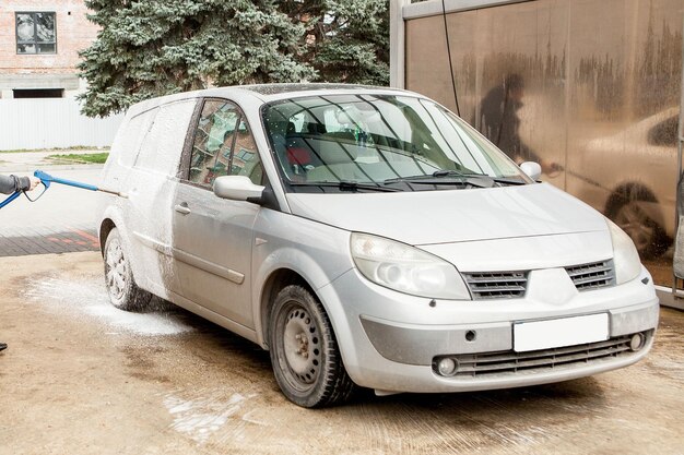 Фото Промывка автомобилей пеной на станции промывки автомобилей промывка машин на станции концепция промывания автомобилей автомобиль в пене