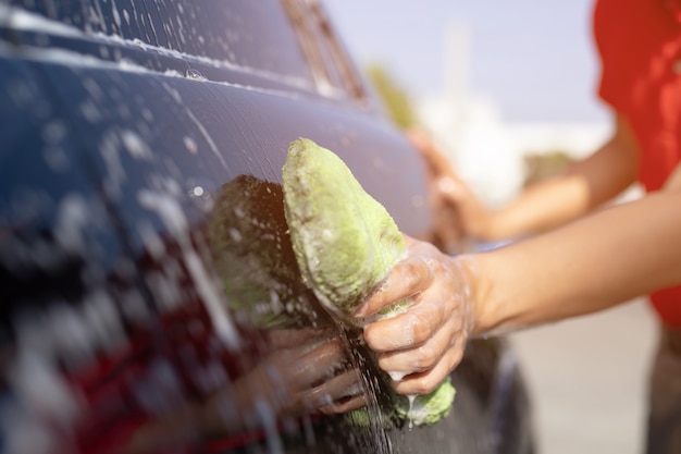 Photo car washing. cleaning car using high pressure water.