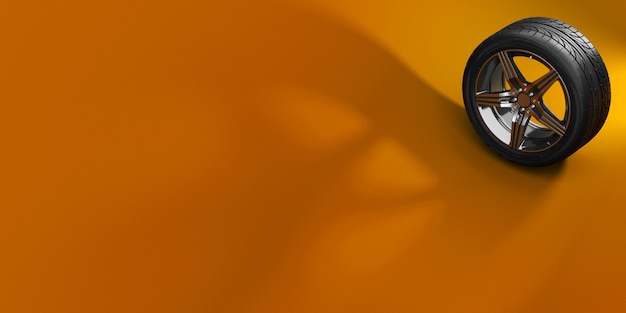 Car wheel isolated on orange background with shadow