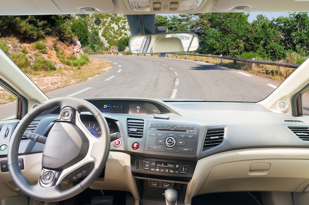 Car windscreen with country road