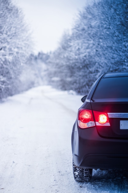 Car in winter in nature outside the city. Snow picture. Snow on the road. Winter road.