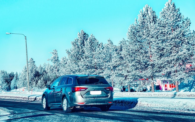 フィンランドの雪のある冬の道路の車。ラップランドの自動車と寒冷地。ヨーロッパの森の自動車。フィンランドの都市高速道路に乗る。道路とルートの雪に覆われたストリートトリップ。運転