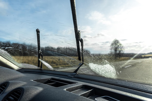 Photo car wipers clean windshields when driving in sunny weather