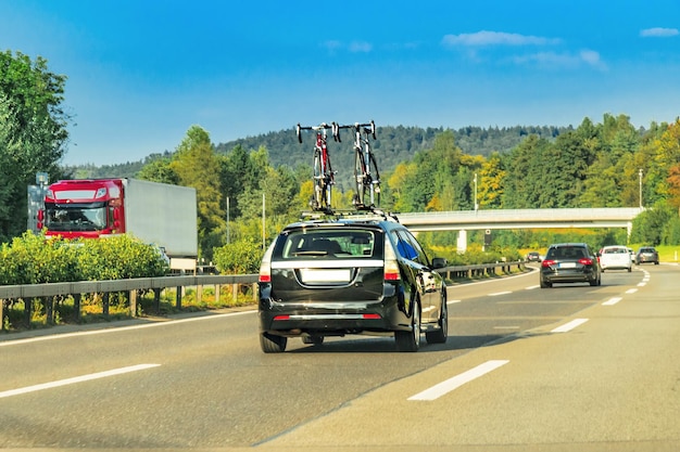 Car with bicycles in the highway of Switzerland.