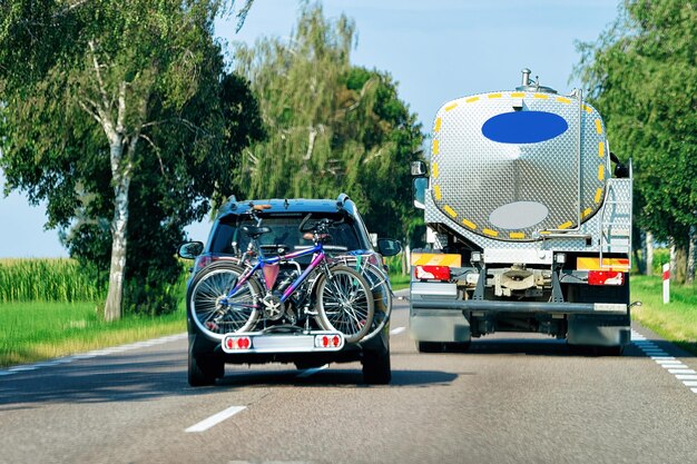 Car with bicycles in the road in Poland.