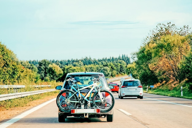 Car with bicycles on road in Switzerland.