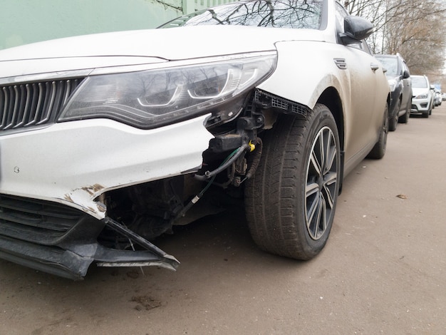 Car with broken bumper in street