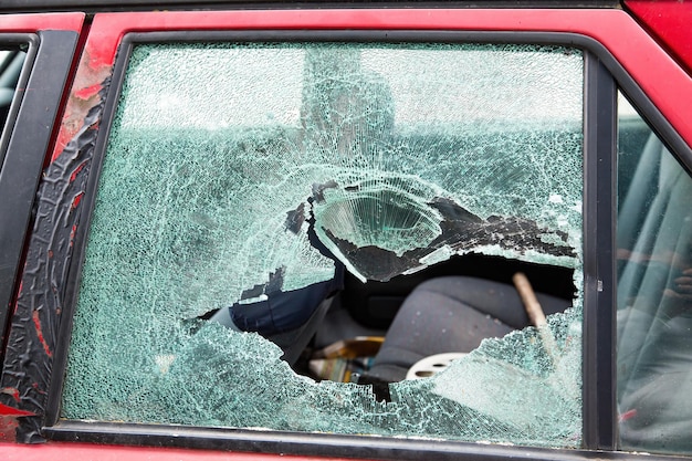 Car with broken windows A criminal incident Broken glass window car damaged has accident Broken glass Thief broken glass in car window