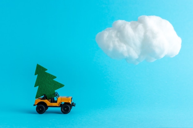 Car with Christmas tree against cloud