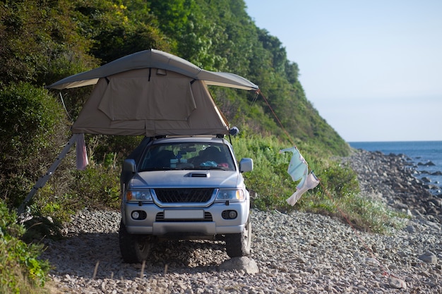 Car with roof tent at the sea shore