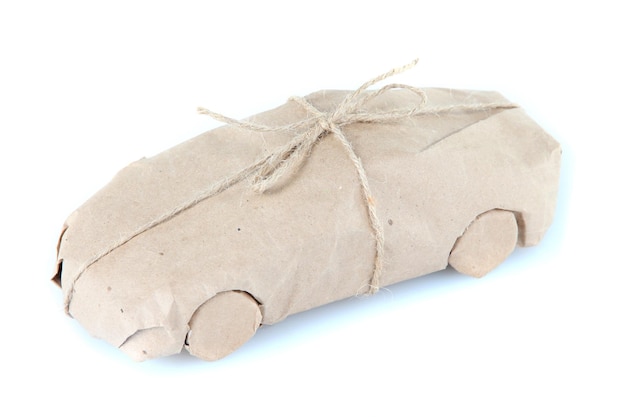 Car wrapped in brown kraft paper isolated on white